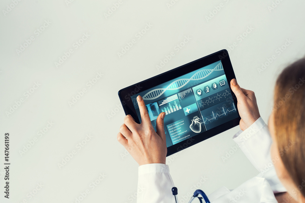 Close of female doctor hands working with tablet pc computer