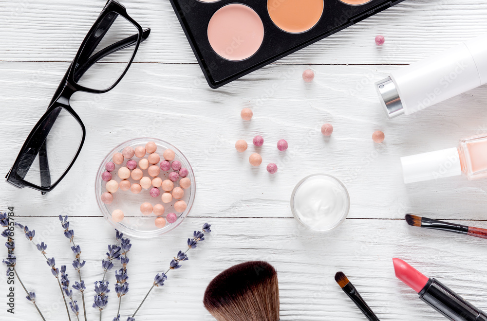 set of cosmetics for women with lavender office background top view