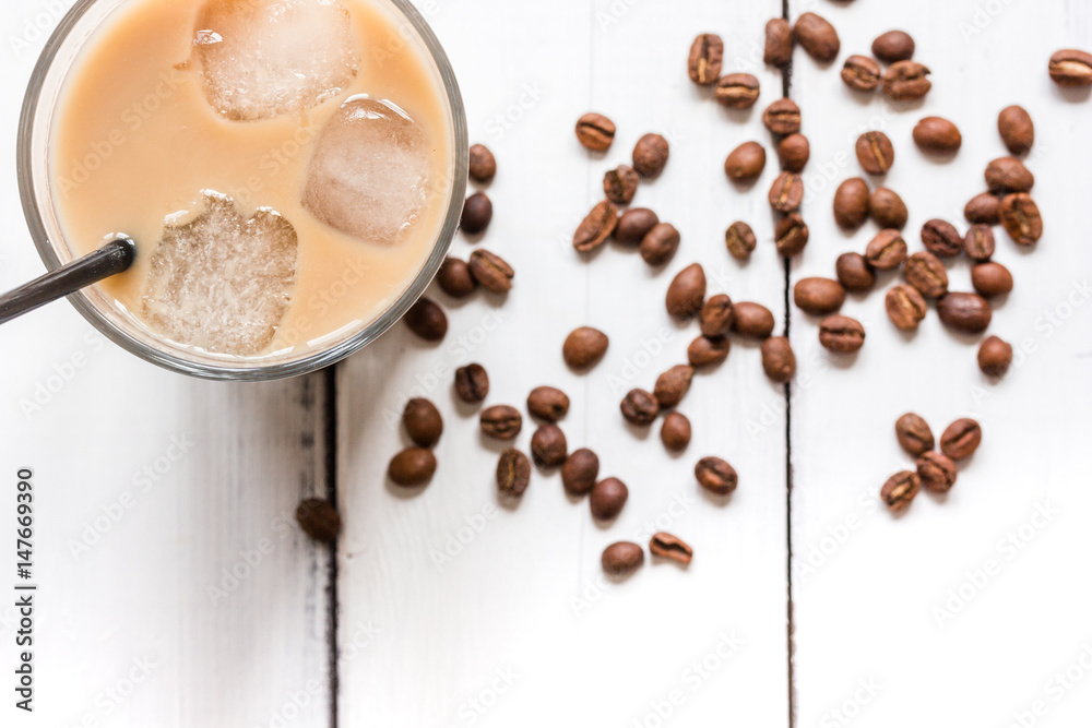 Ice coffee with milk for lunch on white wooden background top view