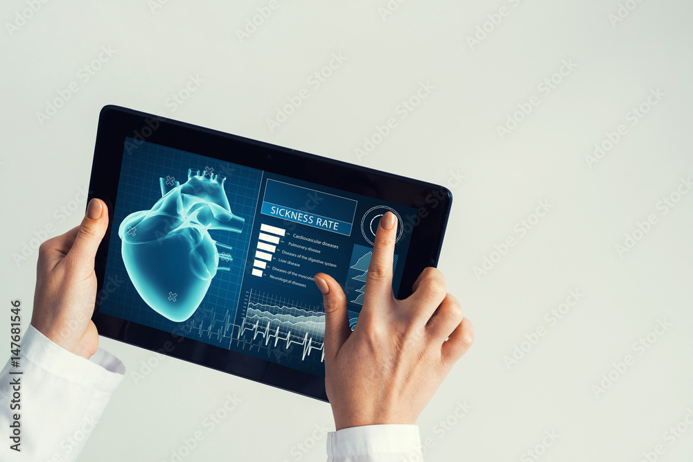 Close of female doctor hands working with tablet pc computer