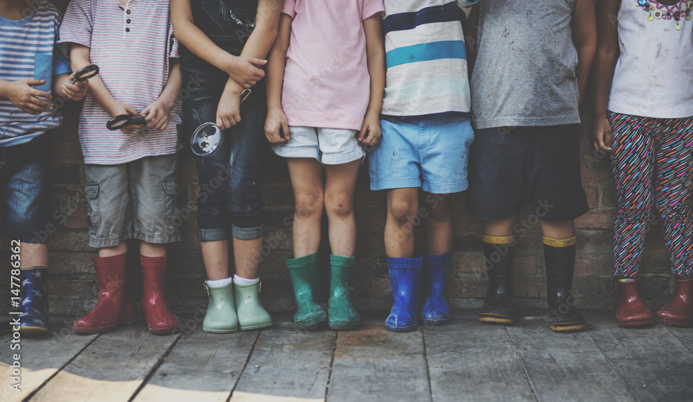 Group of kindergarten kids friends holding magnifying glass for explore