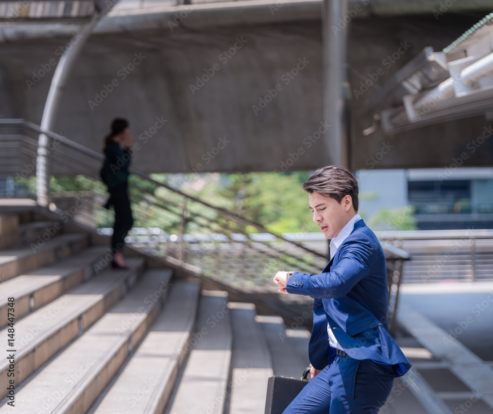 businessman in a hurry checking time and running, he is late for work his business appointment