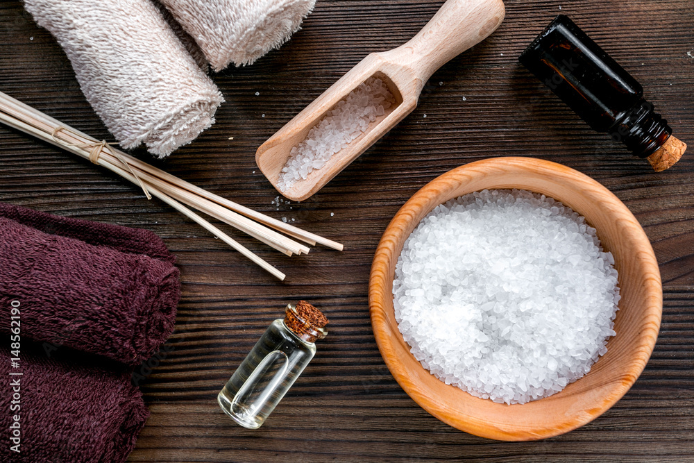 Aromatherapy SPA set with salt and natural oil wooden background top view