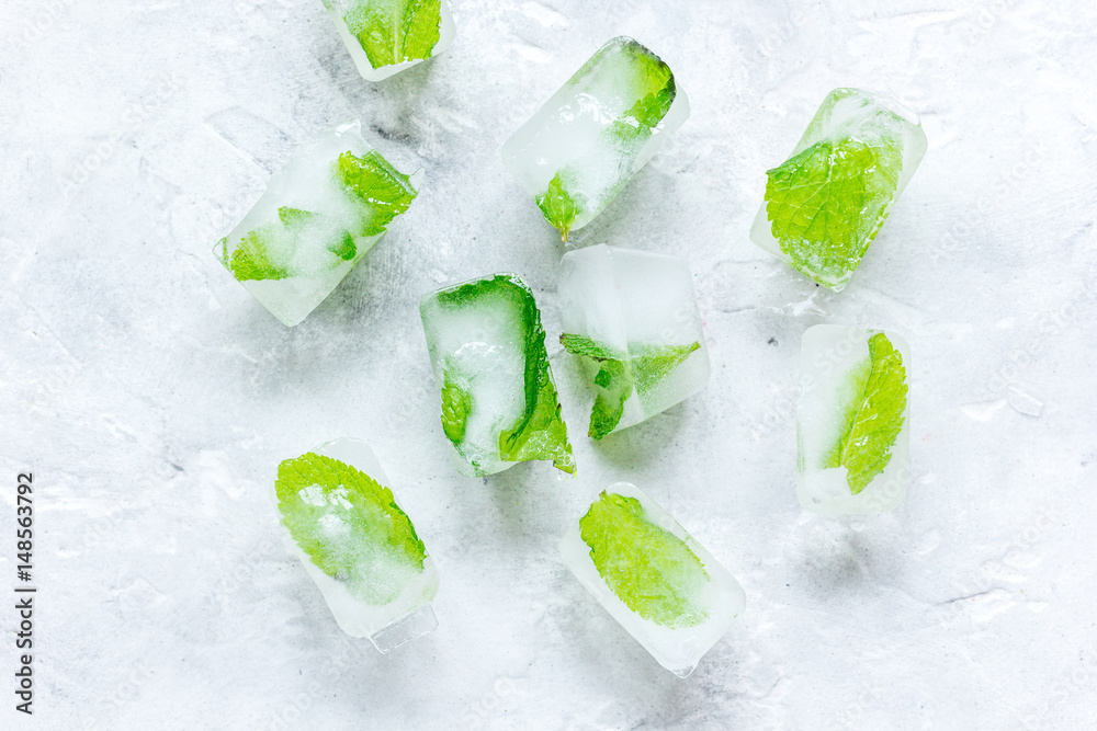 Ice cubes with mint stone background top view