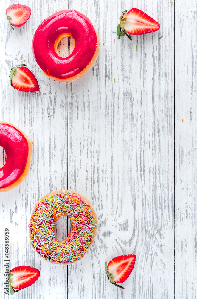 food design with strawberry donat on wooden table background top view mockup