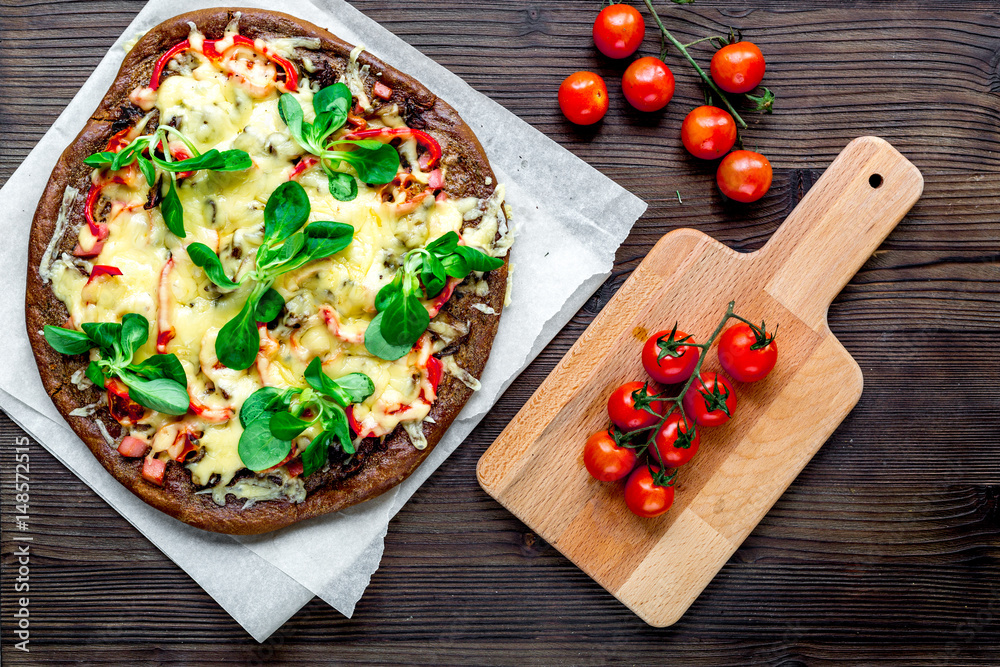 cooking pizza with vegetables and cheese on wooden desk background top view