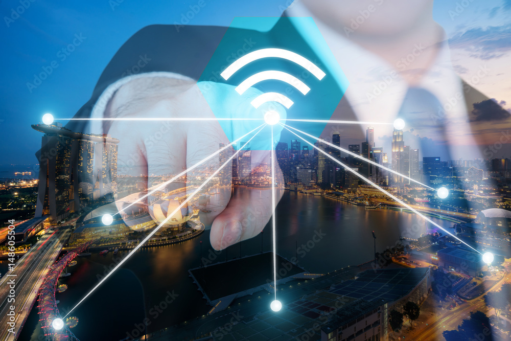 Businessman push wifi icon on city and network connection concept. Singapore smart city and wireless