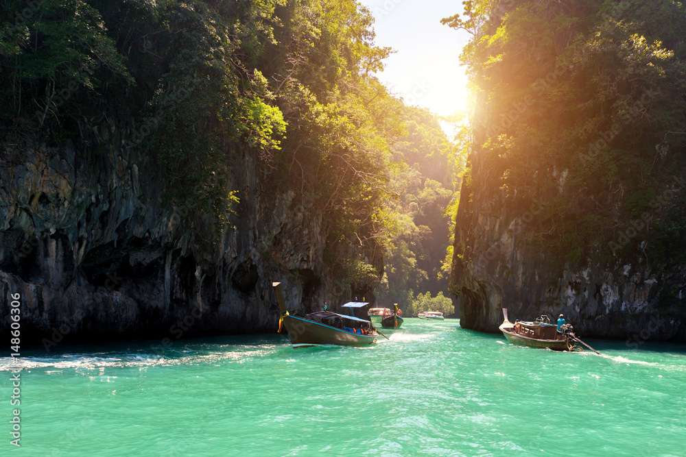 Beautiful landscape of rocks mountain and crystal clear sea with longtail boat at Phuket, Thailand. 