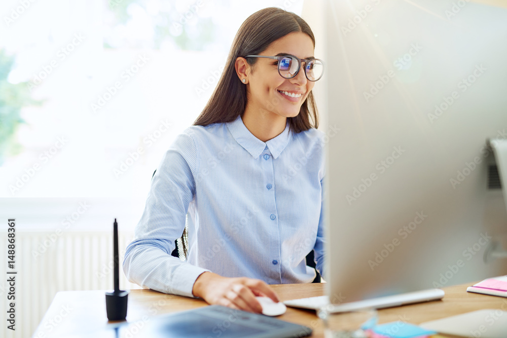 Smiling digital artist working on computer