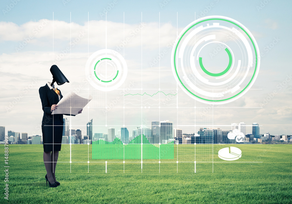 Camera headed woman standing on green grass against modern citys