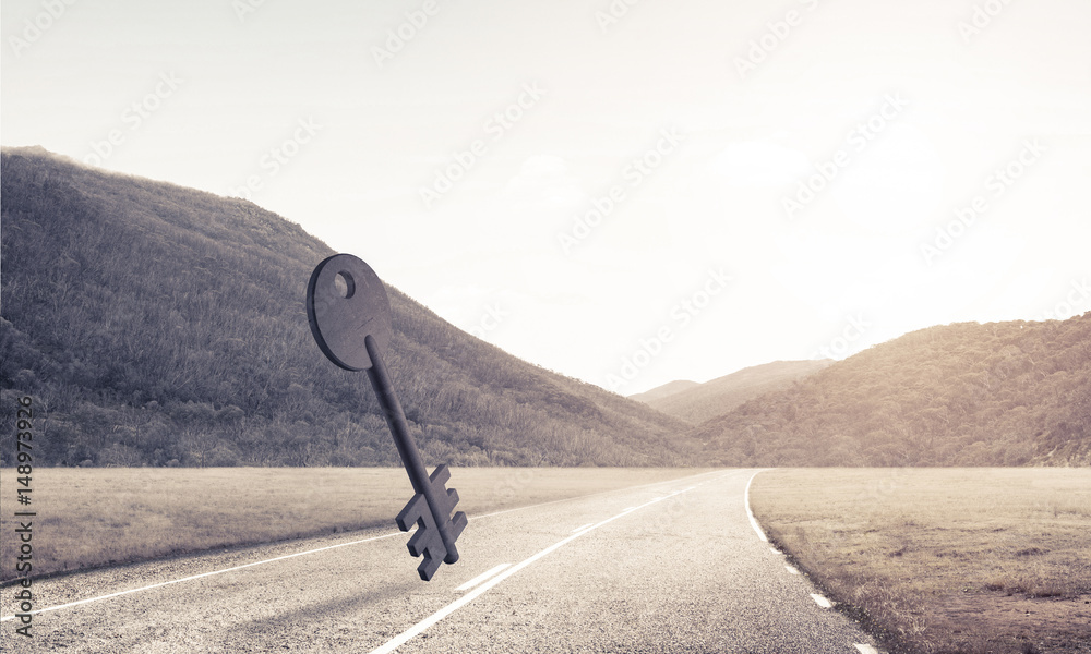 Conceptual background image of concrete key sign on asphalt road