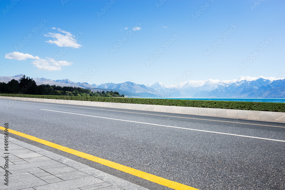 empty road with blue sea in blue sky