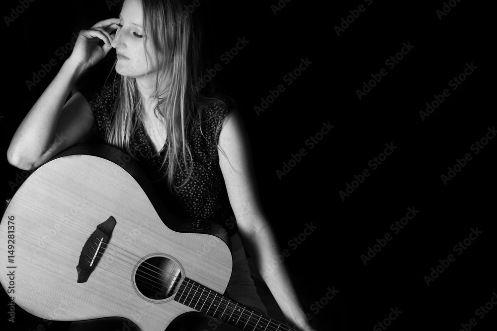 Young woman playing a guitar.