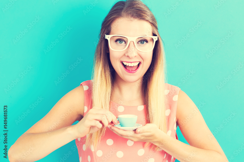 Happy young woman drinking coffee