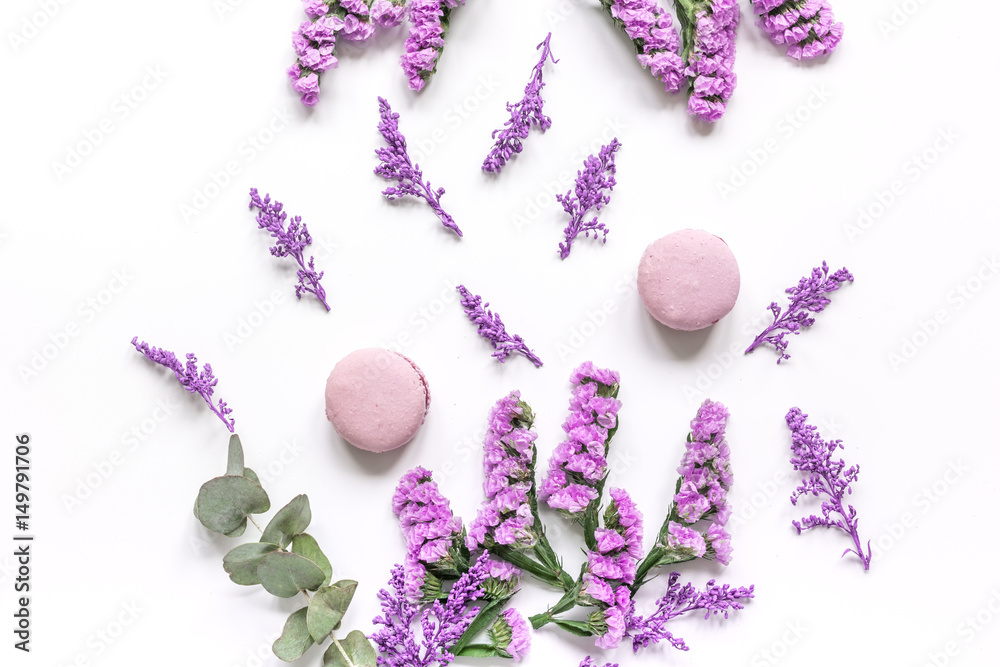 spring woman breakfast with macaroons and flowers white background top view