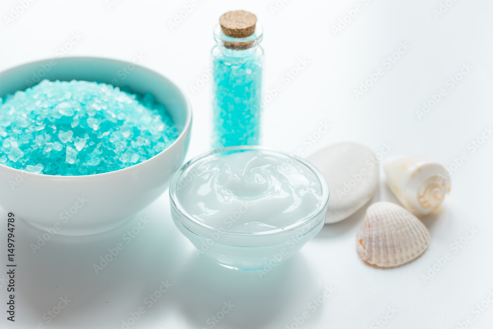 blue sea salt and body cream on white desk background