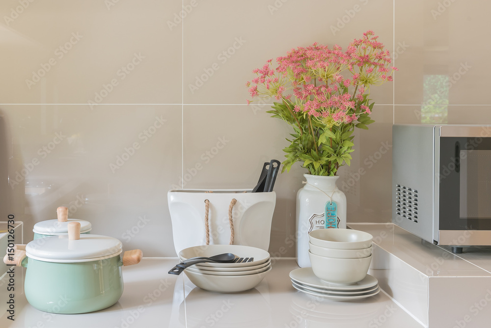 kitchen counter with ceramic bowl, pot, plates