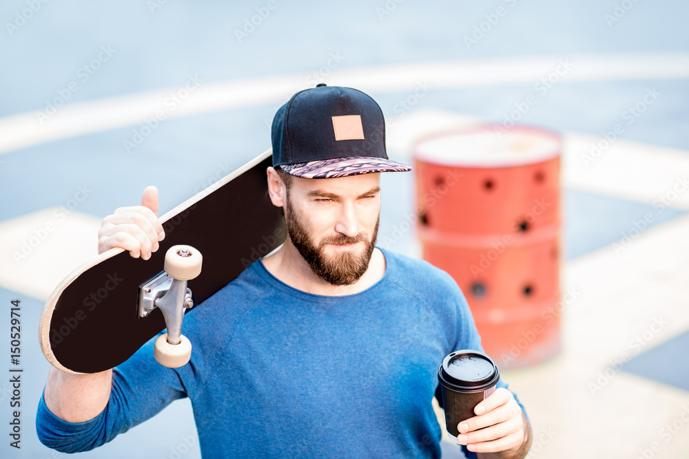 Skateman drinking coffee outdoors