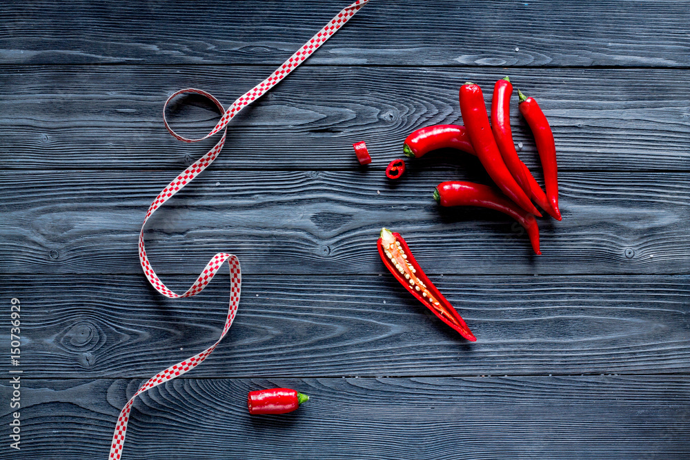 red chili pepper frame design on dark table background top view