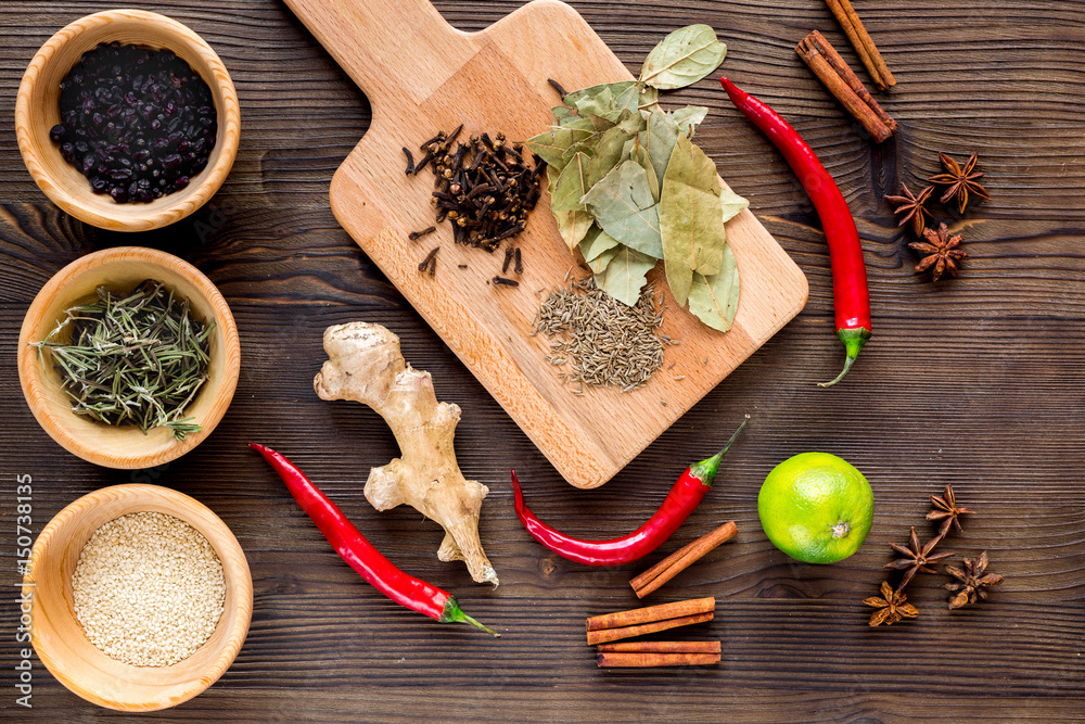 Dry colorful spices, chili pepper on kitchen wooden table background top view