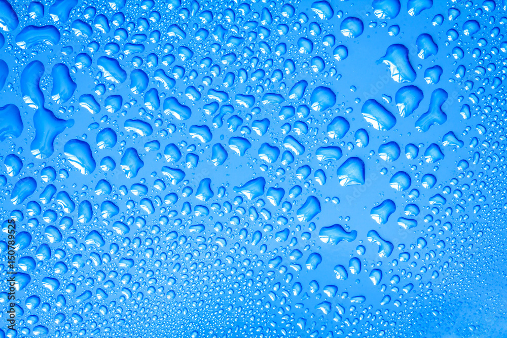 The Abstract water drop on surface of  fresh blue background