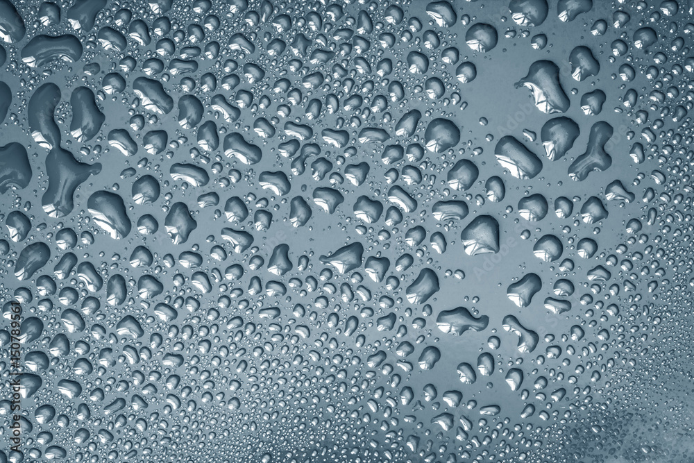 The Abstract water drop on surface of  fresh dark gray background