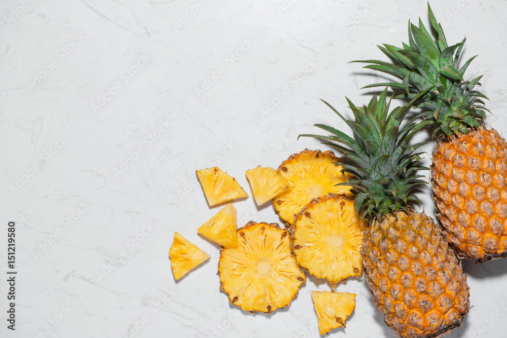 Top view of fresh sliced pineapple on a marble background.