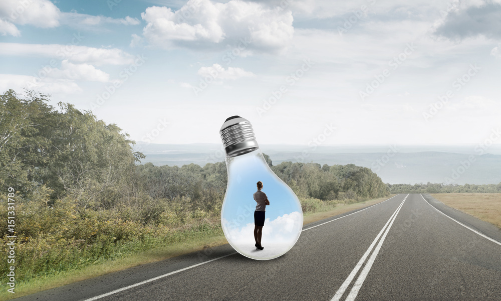 Businesswoman inside light bulb