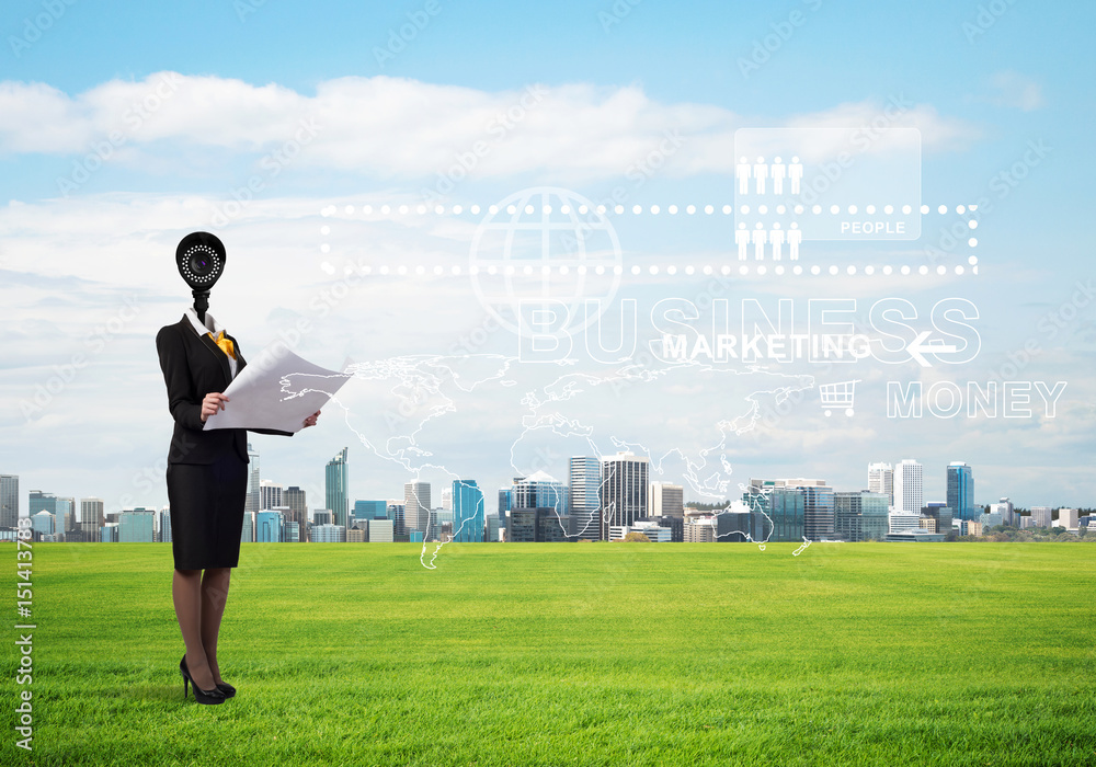 Camera headed woman standing on green grass against modern cityscape