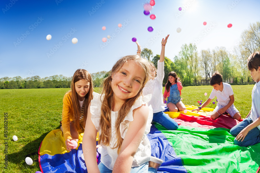 Smiling girl playing with friends in the park