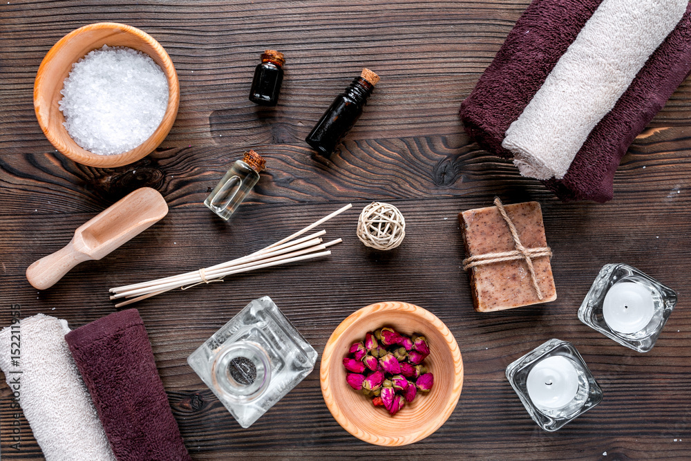 spa cosmetics with soap, salt, oil on white background top view