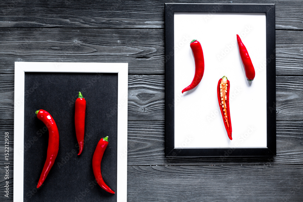 chili food with red pepper in frames on dark background top view