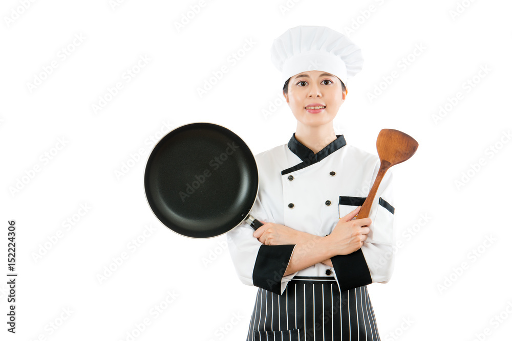 professional chef showing pan and wooden spatula