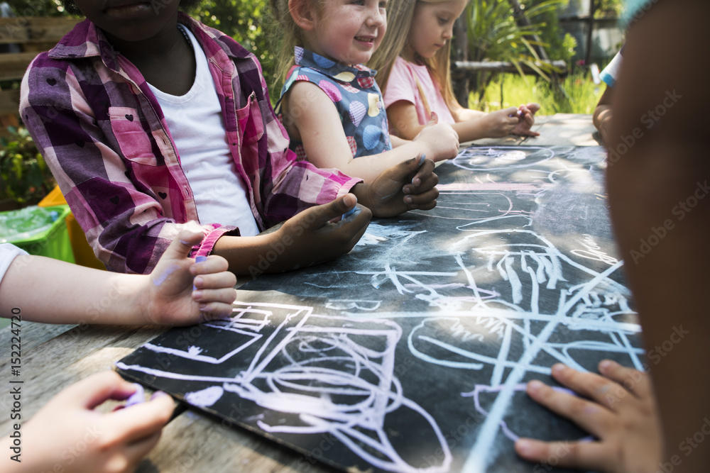 Group of kindergarten kids friends drawing art class outdoors