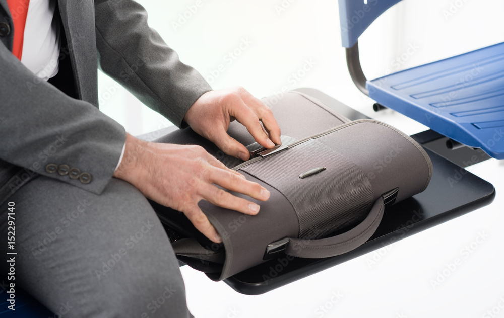 Corporate businessman opening his bag