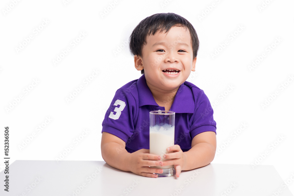 Little happy asian boy with glass of milk isolated on white background