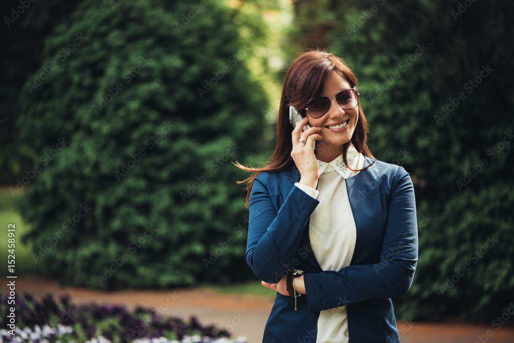 Smiling lady talking on the mobile phone