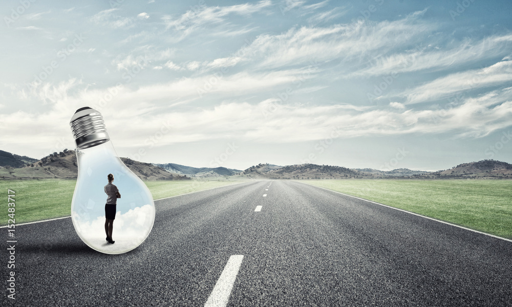 Businesswoman inside light bulb