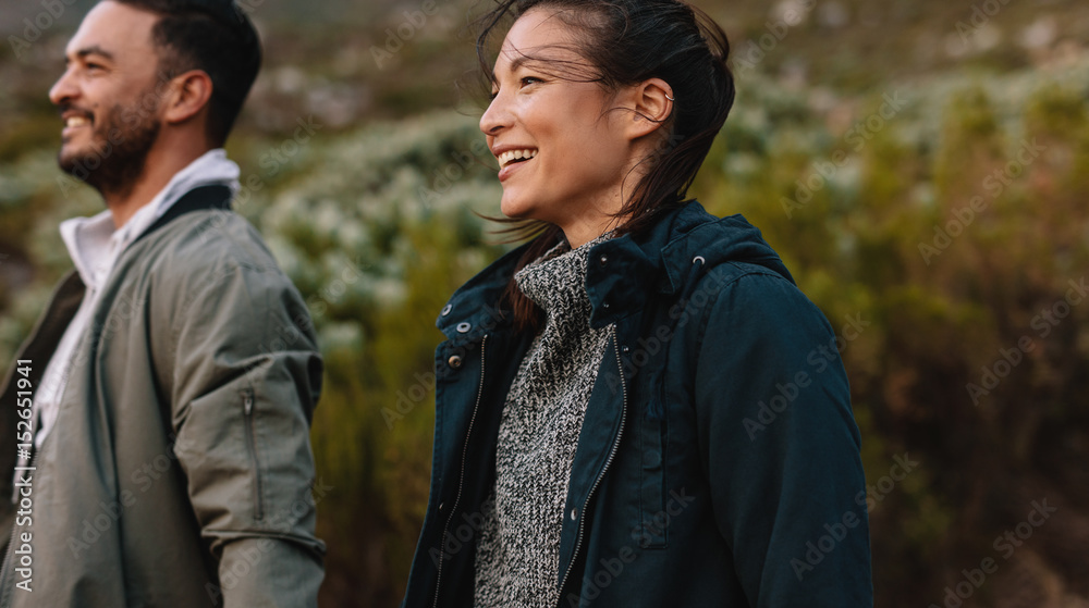 Smiling couple hiking in countryside