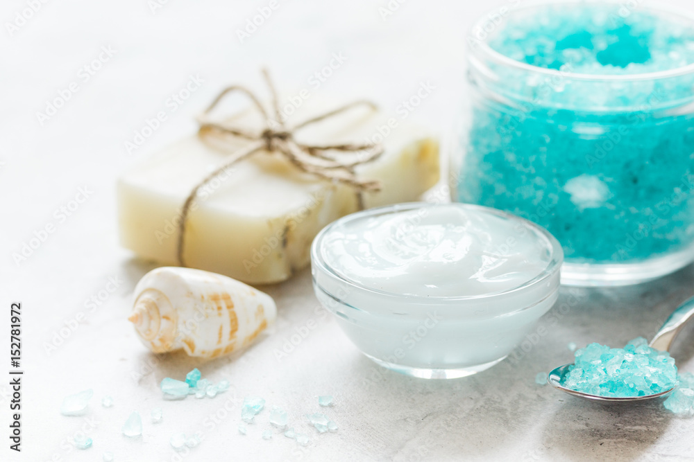 blue spa composition with blue sea salt and natural soap on stone desk background