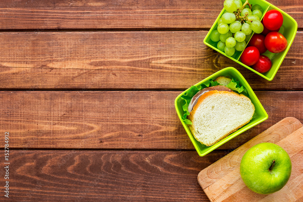 healthy food in lunchbox for dinner at school wooden table background top view mockup