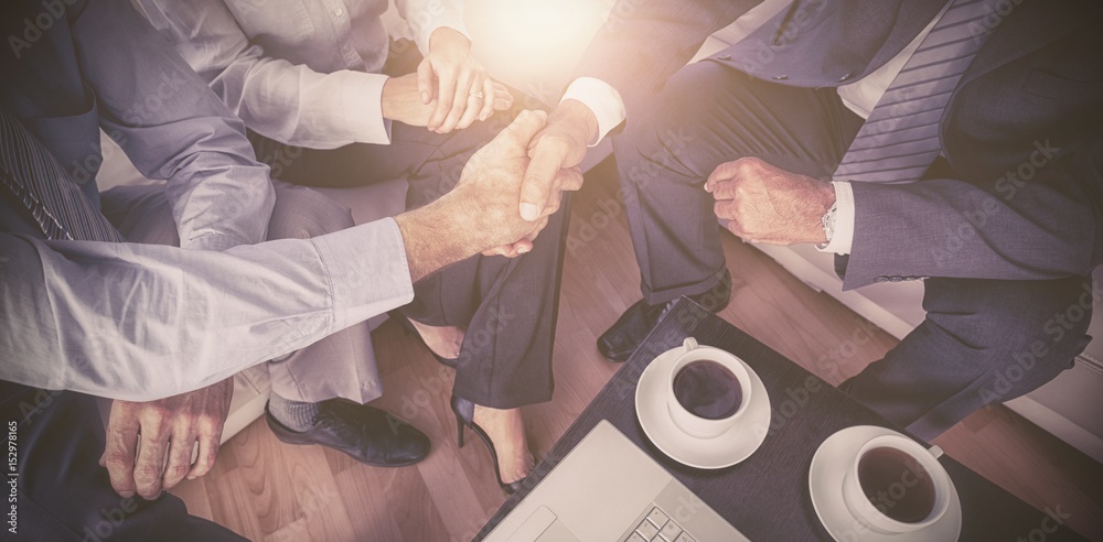 Executives shaking hands in meeting