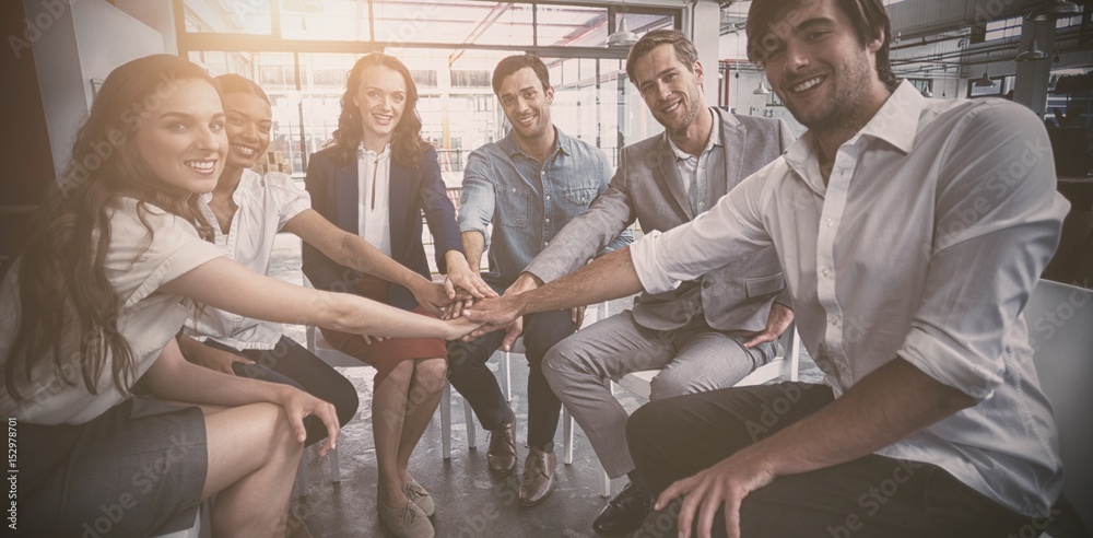 Business people forming hand stack