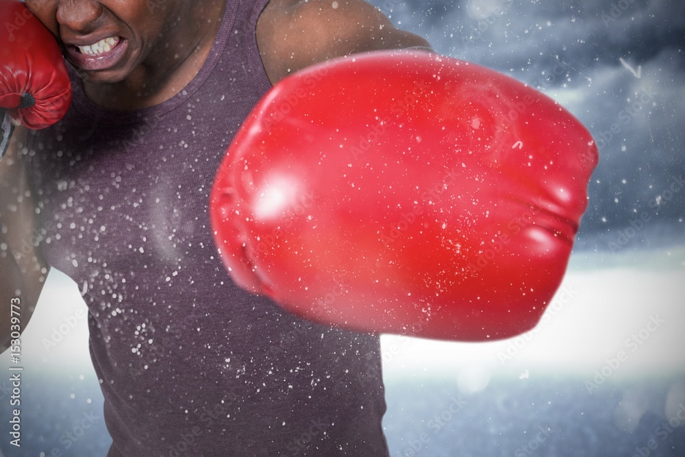 Composite image of fit man with boxing gloves 