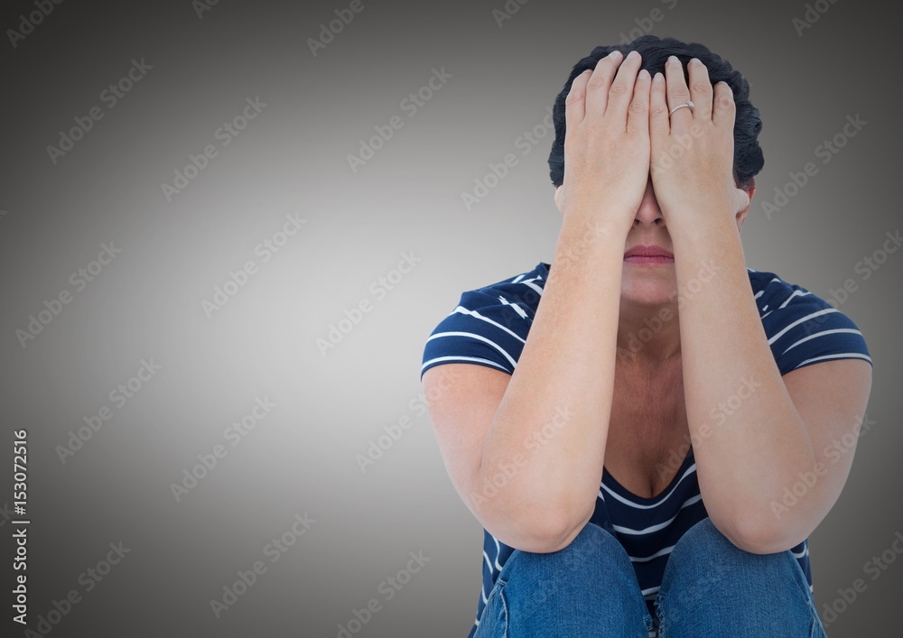 Woman sitting with hands on face