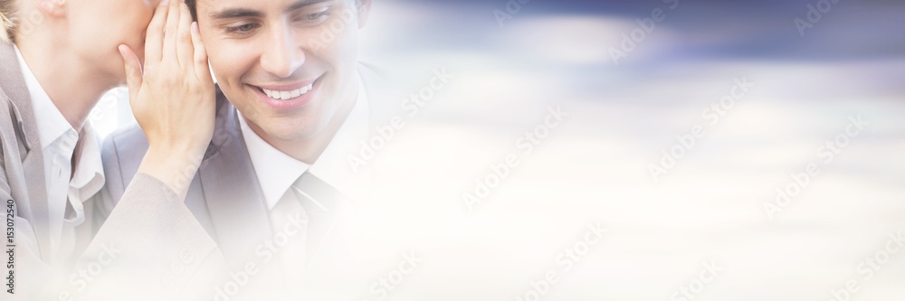 Young businesswoman whispering something to her colleague