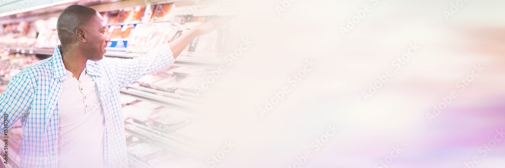 Man looking at goods in grocery section while shopping