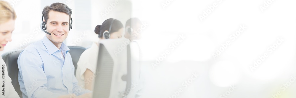 Business colleagues with headsets using computers