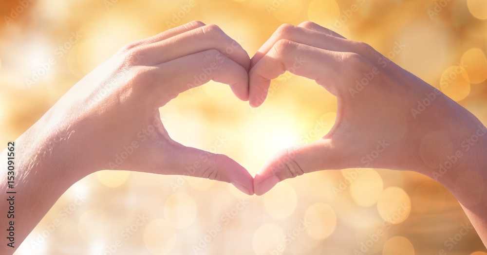 Image of couple making heart shape with hands 