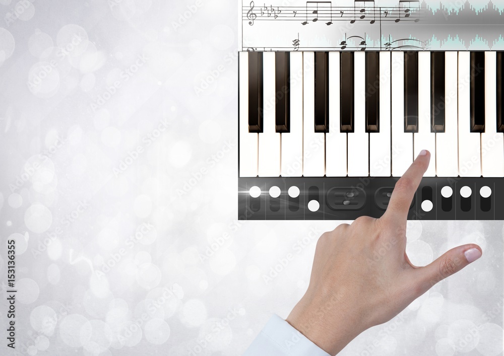 Hand Touching Piano keys with notes 